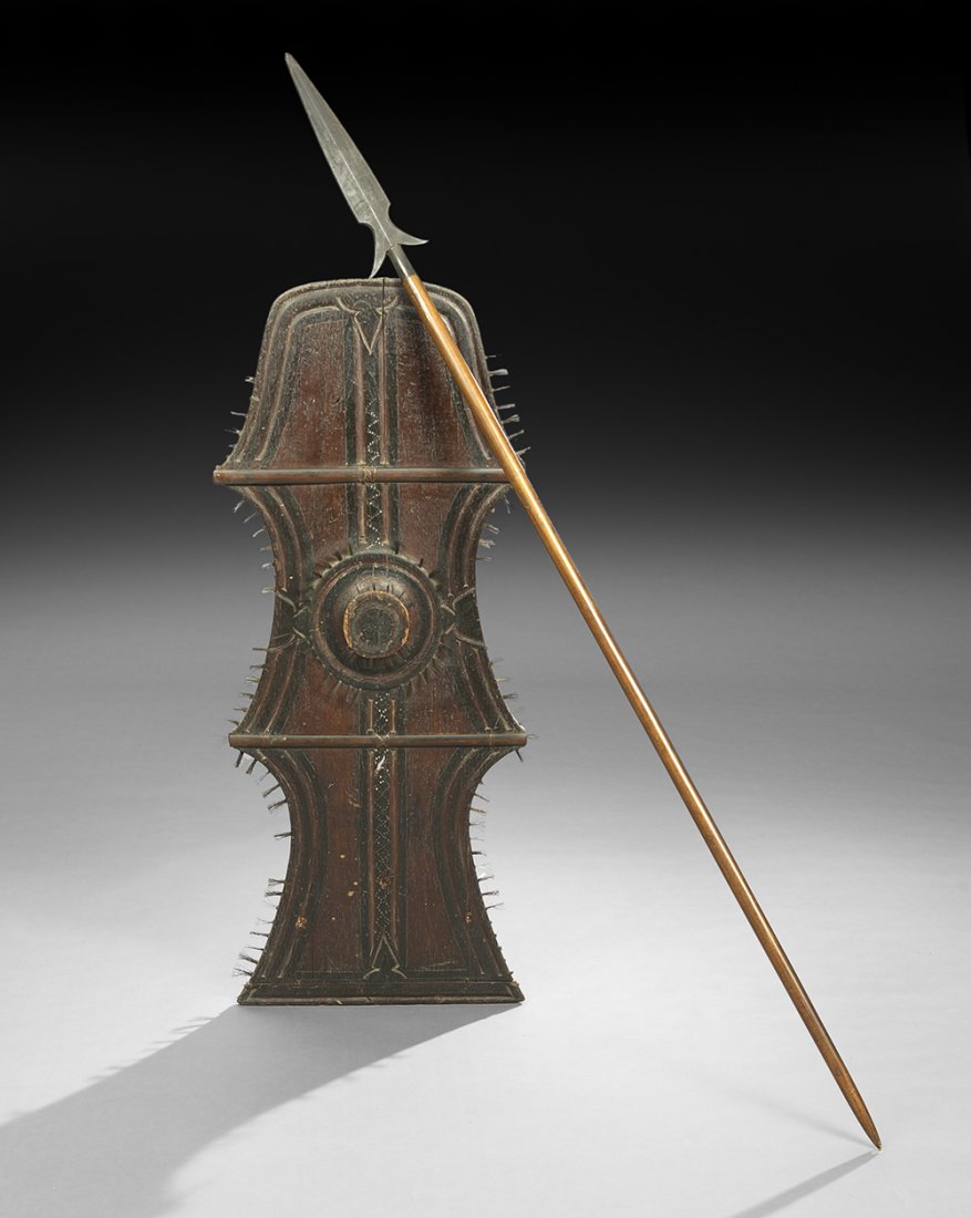 Tribal Bristle-Carved and Painted Wooden Shield: Tribal Bristle-Carved and Painted Wooden Shield, h. 43", w. 18", with a metal-tipped wooden spear, l. 88-1/4", probably African.