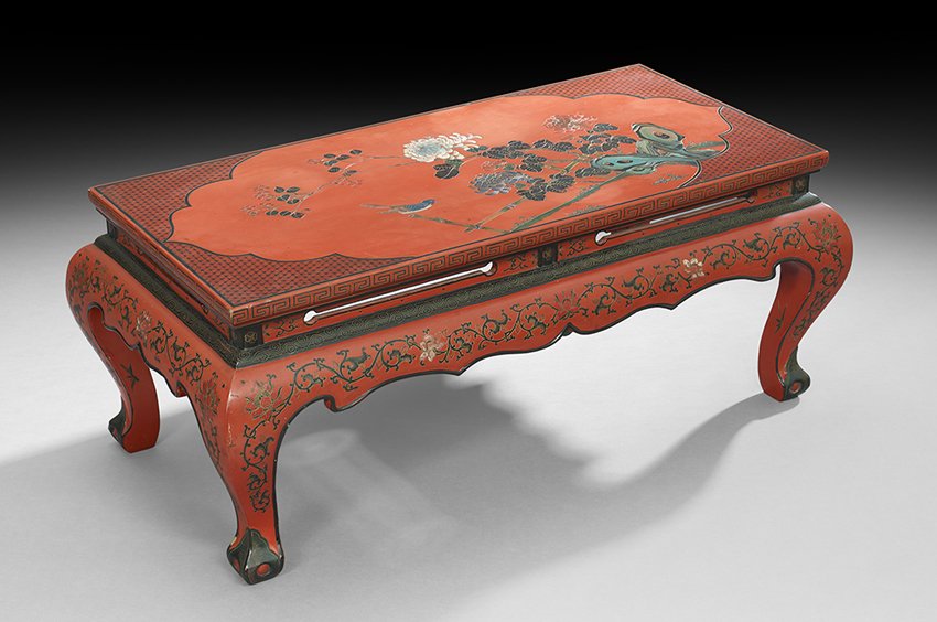 Chinese Red Lacquer Coffee Table: Chinese Red Lacquer Coffee Table, 20th century, with a motif of peonies and scholar's rocks across the top and a scrolling floral design on the sides, h. 16-1/2", w. 18", l. 40".