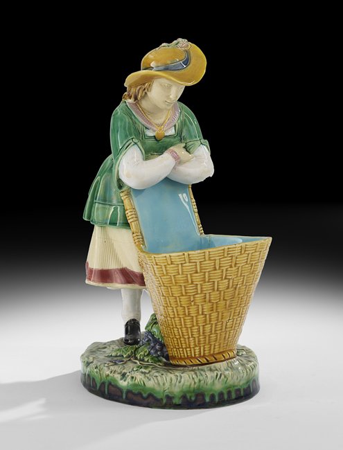 Minton Molded Majolica Figural Spill Vase: Minton Molded Majolica Figural Spill Vase, ca. 1860-1872, English, in the form of a girl with a basket, decorated in polychrome enamels, impressed "Minton" on the base, h. 8-1/2", w. 3-1/4", d. 6-1/2"