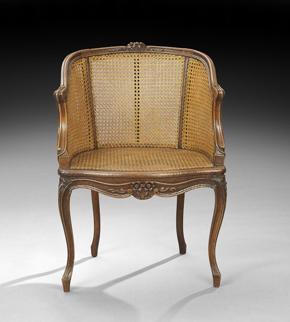 French Fruitwood and Caned Bergere: French Fruitwood and Caned Bergere, second quarter 20th century, in the Louis XV style, carved with flowers, h. 33".