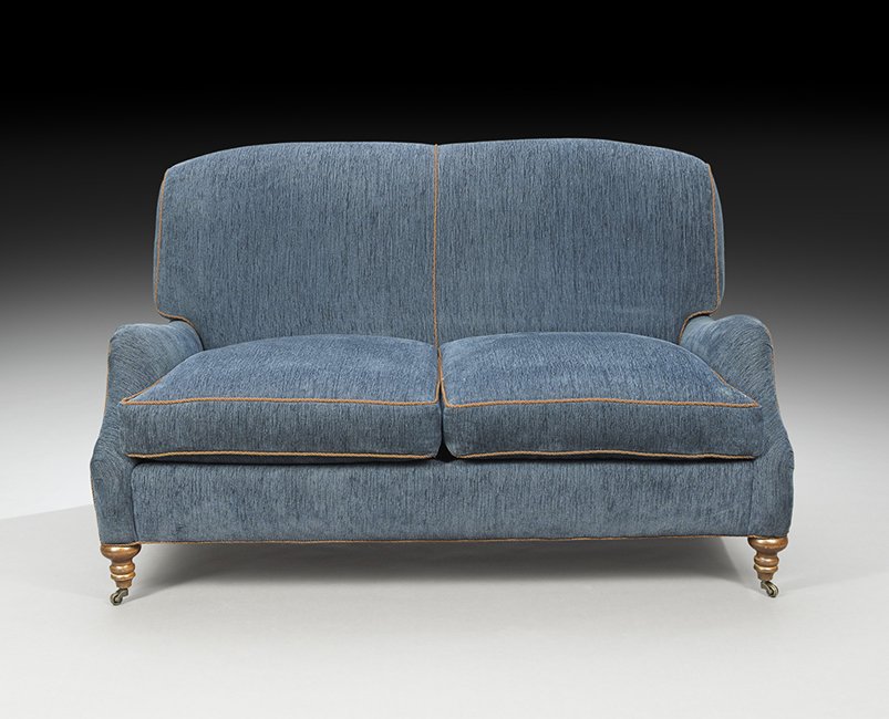 Contemporary Upholstered Sofa: Contemporary Upholstered Sofa, the seat fitted with loose cushions, a low arm and turned legs, upholstered in deep blue with brown cord, h. 33-1/2", w. 56-1/2", d. 40".