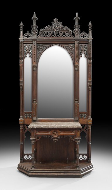 American Gothic Revival Walnut Hall Tree: American Gothic Revival Walnut Hall Tree, third quarter 19th century, the arched mirror plate flanked by narrower mirrors with Gothic tracery, the open-carved crest with carved spires, oak leaves and 