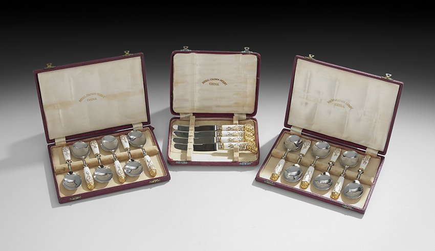 Set of Royal Crown Derby and Steel Flatware: Sixteen-Piece Set of Royal Crown Derby Porcelain and Steel Flatware, ca. 1921-1940, including twelve spoons, l. 7-1/4", with grape-molded handles, in the original boxes, and four knives, marked on the