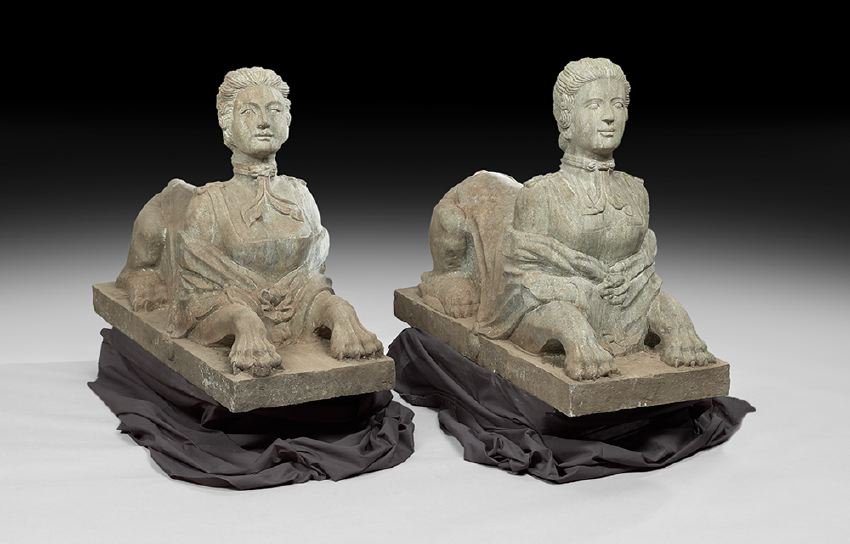 Pair of Carved Granite Garden Figures: Pair of Carved Granite Garden Figures, each in the form of a sphinx, with a female bust joined to a recumbent lion's body, on a plinth base, h. 31", w. 42", d. 17". Provenance: Collection of Mario Vil