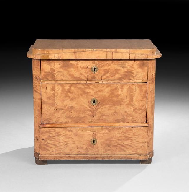 Biedermeier Blonde Fruitwood Chest: Biedermeier Blonde Fruitwood Chest, mid-19th century, the rounded stepped top above a pyramidal frieze with two graduated long drawers below and a deep projecting apron drawer, raised on block feet, h