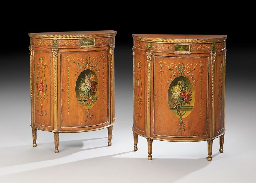 Pair of Edwardian Polychrome Demi-lune Cabinets: Pair of Edwardian Satinwood and Polychrome Demi-lune Cabinets, ca. 1900, each with a demi-lune top with a polychrome foliate garland border and central figural medallion above a guilloche-carved edge,