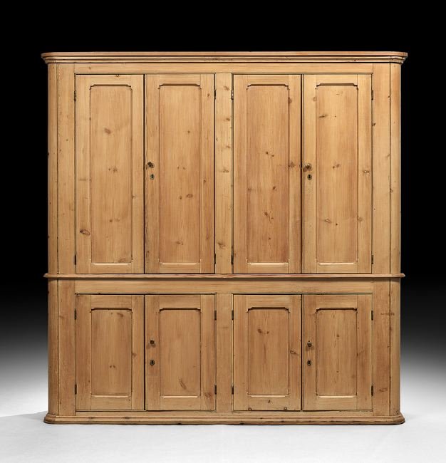 English Pine Cabinet: English Pine Cabinet, early 20th century, the molded cornice with rounded ends above a conforming case fitted with four paneled cupboard doors, the lower section fitted with four paneled cupboard door