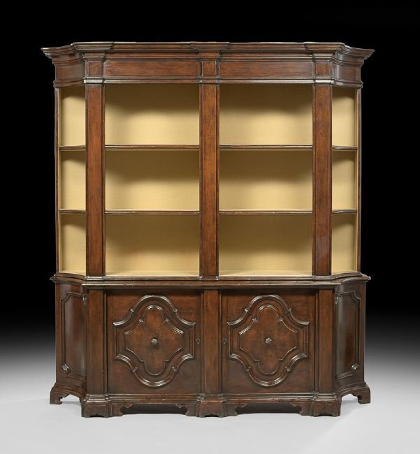 Italian Renaissance-Style Mahogany Bookcase: Italian Renaissance-Style Mahogany Bookcase, the heavily molded cornice with concave corners above three open fabric-lined shelves, the lower section fitted with two doors, each with a shaped panel fl