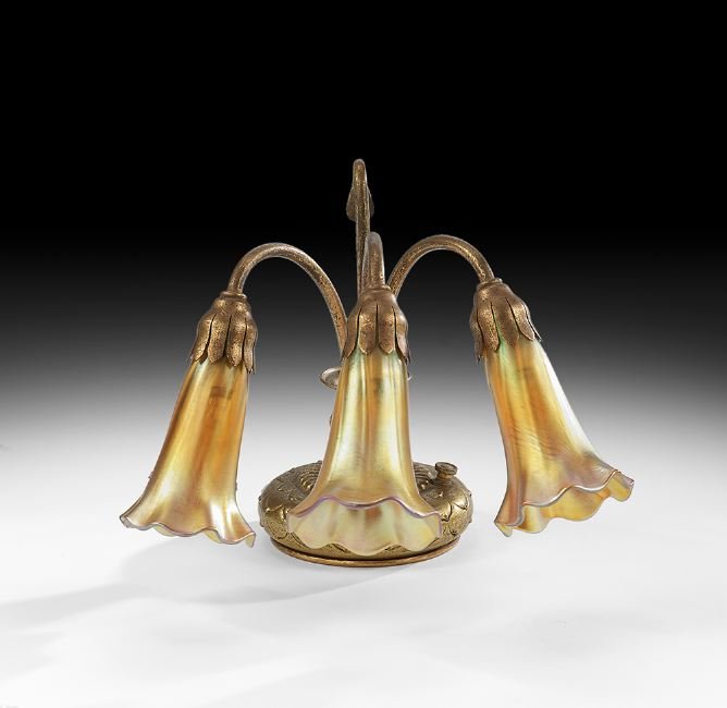 Tiffany Studios Gold Dore "Lily" Lamp: Tiffany Studios Gold Dore Three-Light "Lily" Lamp, first quarter 20th century, New York, the lamp with three flowerhead sockets mounted with unmarked gold iridescent shades and a carry handle to the r