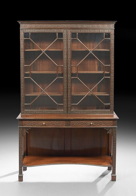 George III-Style Mahogany Cabinet-on-Stand: George III-Style Mahogany Cabinet-on-Stand, 20th century, in the Chinese Chippendale taste, the molded and dentillated cornice above a blind fret-carved frieze, over two astragal-glazed doors, each wi