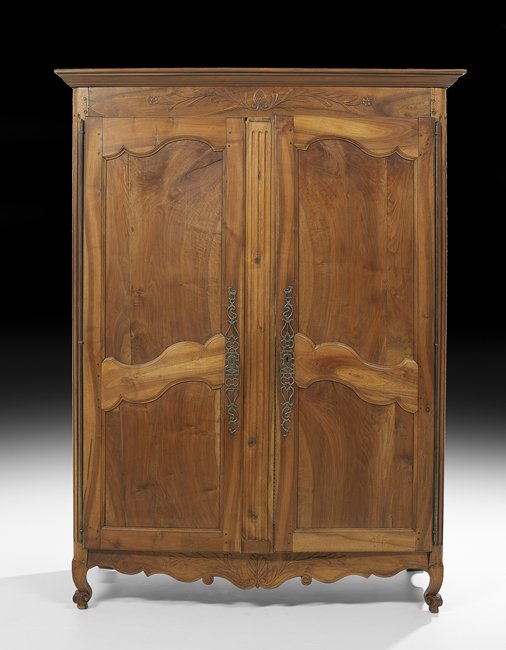 Provincial Louis XV-Style Fruitwood Armoire: Provincial Louis XV-Style Fruitwood Armoire, mid-19th century, the molded cornice above a case fitted with a foliate-carved frieze over two doors, each inset with a shaped panel, raised above a shaped