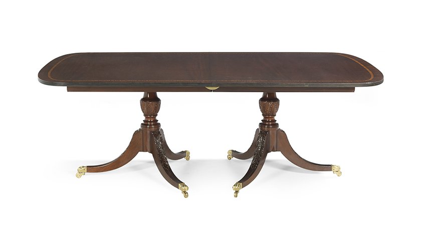 Duncan Phyfe-Style Mahogany Dining Table: Duncan Phyfe-Style Mahogany Two-Pedestal Dining Table, second quarter 20th century, the leaf-carved pedestals supported on leaf-carved reeded sabre legs with brass paw-foot casters, the reeded edge t