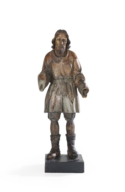 Filipino Santos Figure of San Isidro Labrador: Filipino Carved Wood Santos Figure of San Isidro Labrador, second quarter 19th century, the patron saint of farmers on a contemporary base, presented in his boots and wearing a tunic, the figure retai