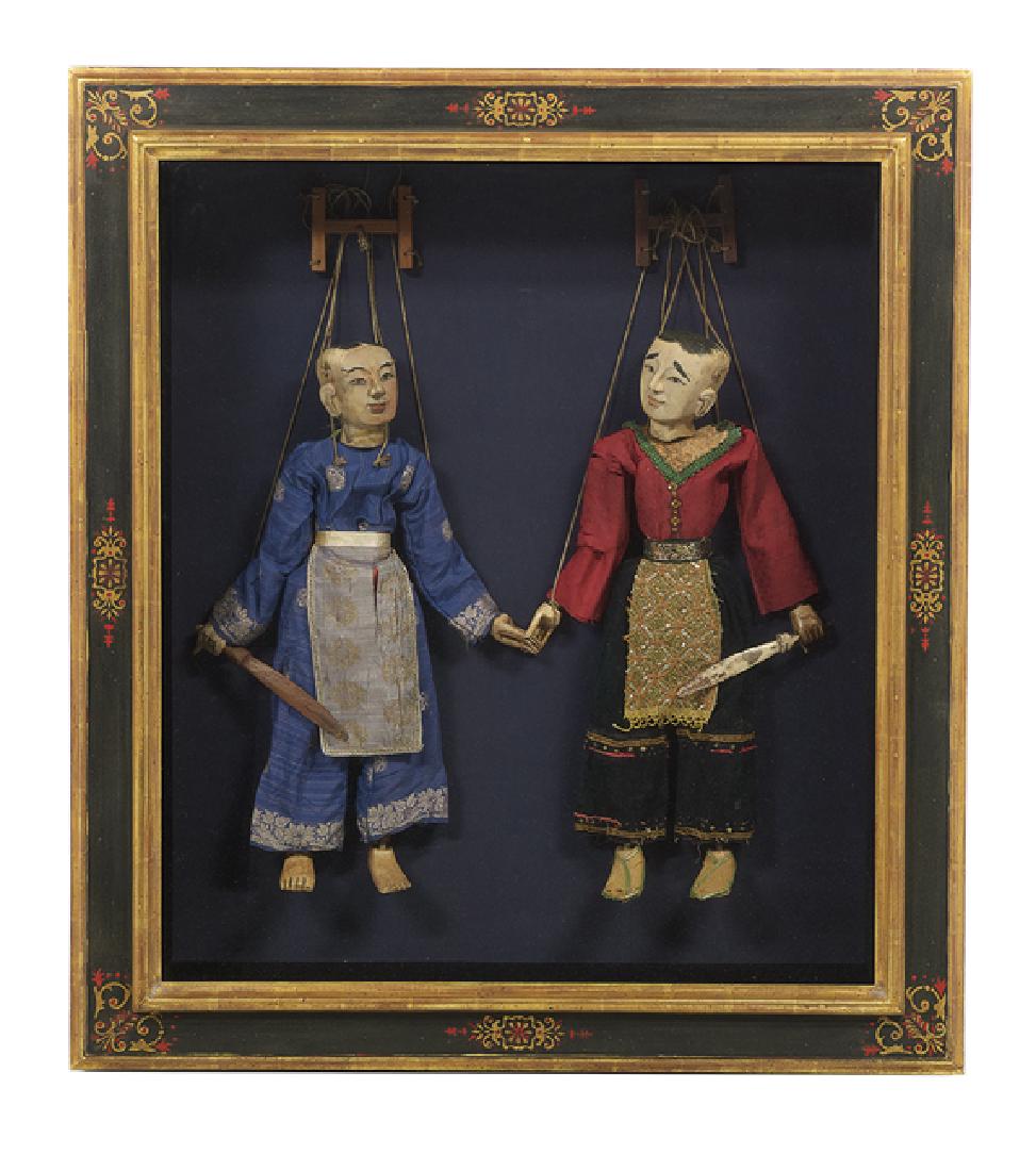 Pair of Burmese Polychrome Wood Marionettes: Pair of Burmese Polychrome and Carved Wood Marionettes, second half 19th century, the male and female figures with hand-painted features and fine, impressive period costumes, h. 26", presented in an e