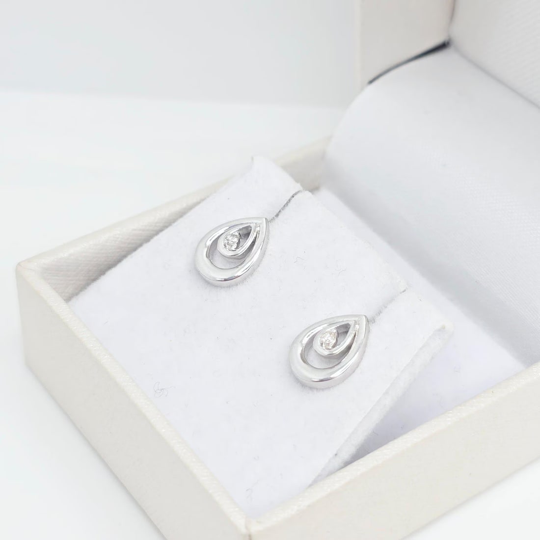 Delicate Pearl-Shape 0.04ct Diamond Stud Earrings in 14K White Gold - Unique: Handcrafted 14K white gold diamond studs with 2 natural round diamonds in a subtle pearl-inspired design. Timeless elegance for everyday wear or special occasions.Elegant and timeless, these handmade