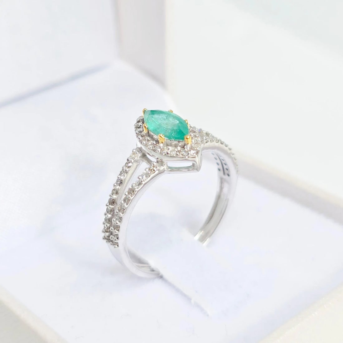 Dazzling 0.49ct Natural Emerald & 0.35ct Diamond Ring in 14K White and Yellow Gold: A stunning handcrafted ring in 14K white and yellow gold, featuring a vibrant 0.49ct natural marquise-cut emerald at its center. The emerald's rich green hue is beautifully accentuated by a halo of 58