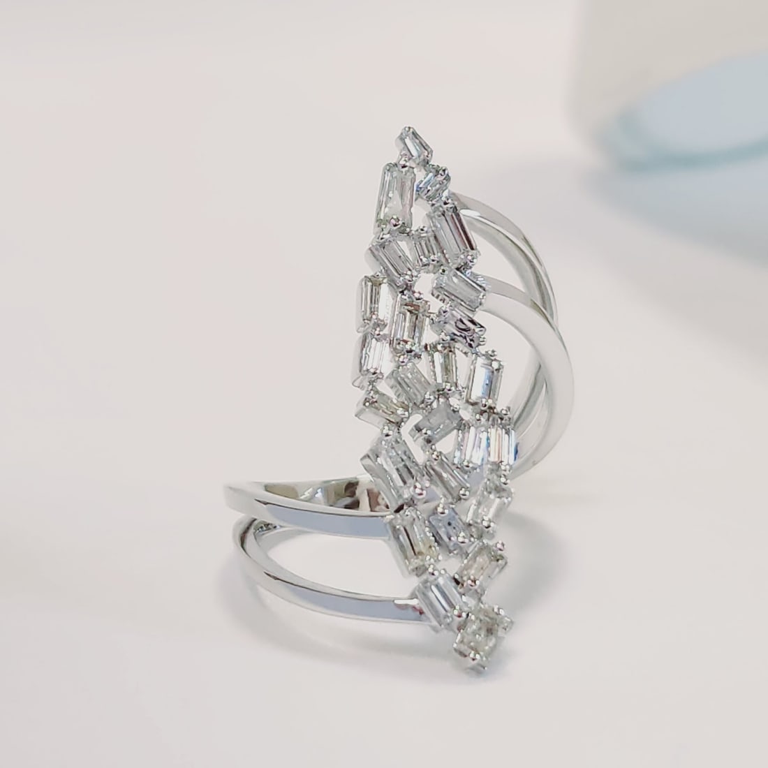 14 kt White Gold Ring with Baguette-Cut Diamonds: Elegant 14 kt White Gold Ring with Baguette-Cut DiamondsRefined and timeless ring crafted in 14 kt white gold, featuring an elegant openwork design set with a cluster of baguette-cut diamonds. The