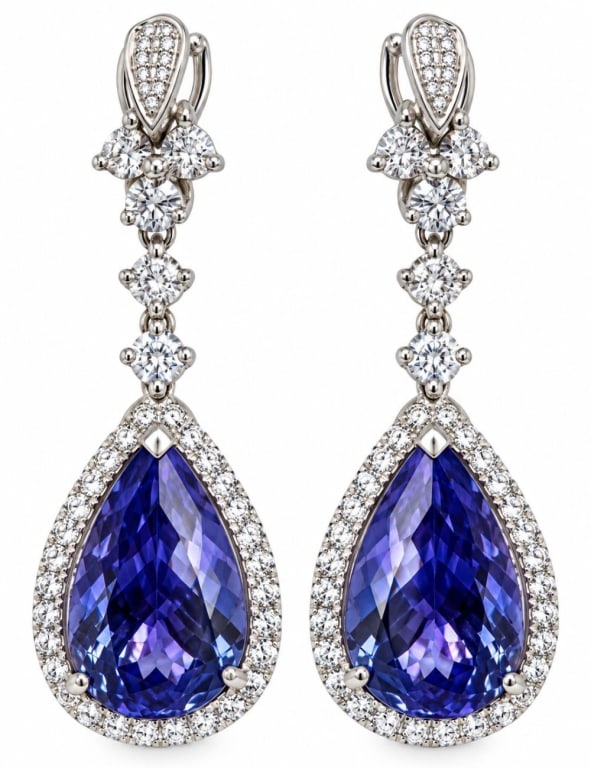 PLATINUM 8.9CT TANZANITE & DIAMOND DROP EARRINGS: Pair of platinum ladies drop earrings, each set with a pear brilliant-cut natural tanzanite surrounded by a halo of round brilliant-cut diamonds, with additional articulated diamond-set elements above