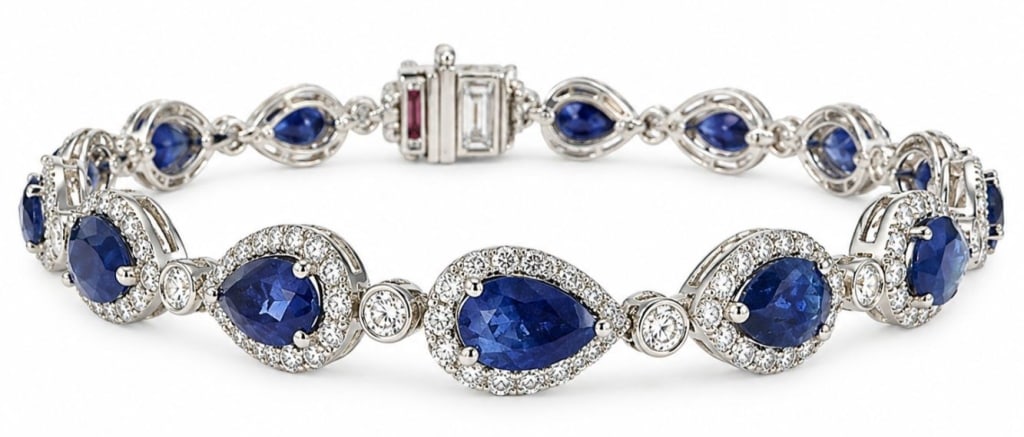 PLATINUM 8 CTW NATURAL SAPPHIRE & DIAMOND BRACELET: Platinum bracelet set with 15 pear brilliant-cut natural blue sapphires weighing approximately 8.24 carats total, accented by 225 round brilliant-cut natural diamonds weighing approximately 2.18 carat