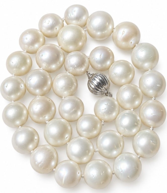 33 SOUTH SEA CULTURED PEARL 14K GOLD NECKLACE 103G: Single-strand necklace composed of 33 cultured South Sea pearls, graduated from approximately 12 to 14.8 mm, individually hand-knotted and measuring approximately 18 inches long. The round to near-rou