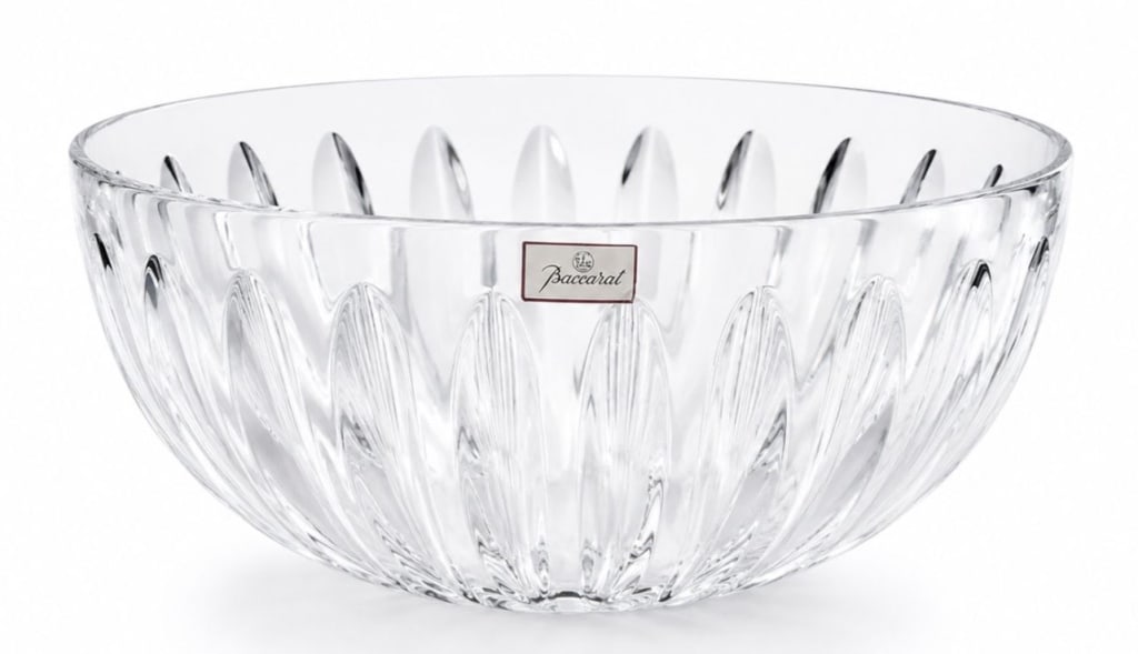 BACCARAT FRENCH CLEAR CRYSTAL FLUTED CENTER BOWL: Baccarat clear crystal center or punch bowl featuring a substantial circular form with deeply molded radiating flutes extending from the base toward the rim. Retains its original red-bordered Baccarat