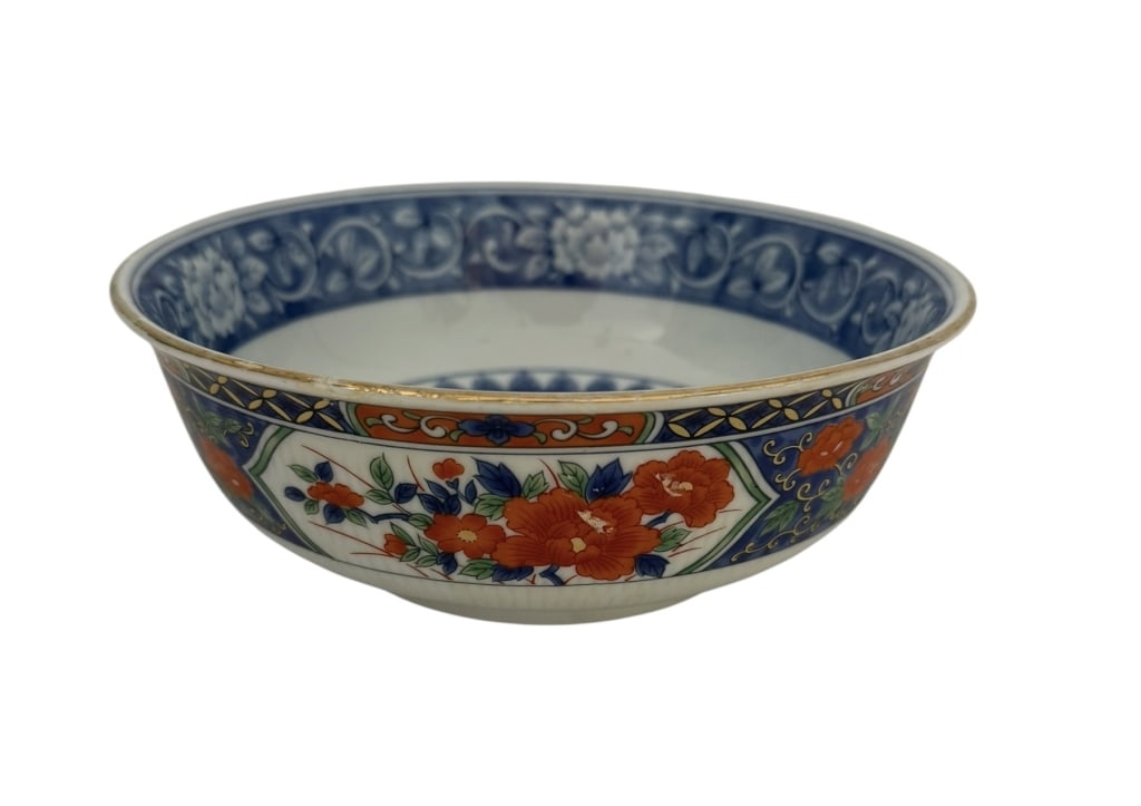 TIFFANY & CO. JAPANESE IMARI STYLE PORCELAIN BOWL: This porcelain bowl features a deep circular form with steep sides and a high, slightly tapered footring. The interior is decorated in underglaze cobalt blue, centered by a medallion containing two bl
