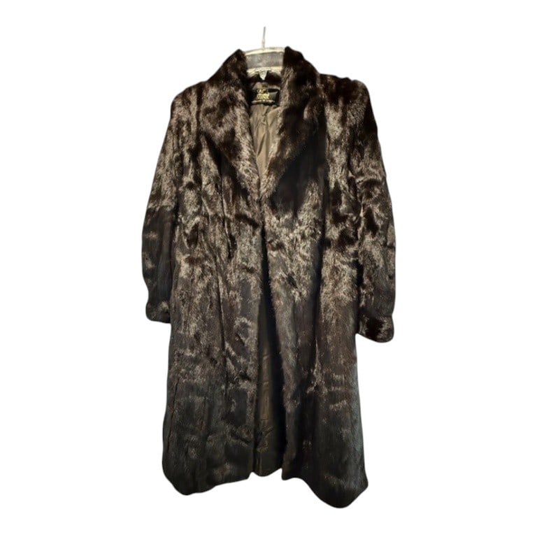 SAGA MINK FULL LENGTH MAHAGONY FUR COAT: This vintage full-length mink coat is crafted from mahogany brown fur featuring a natural high luster. The garment is designed with a wide notched lapel collar and long sleeves, utilizing vertical pel