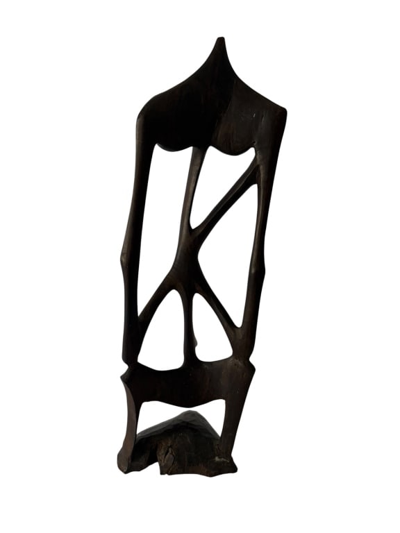 AFRICAN ABSTRACT CARVED WOOD FIGURAL SCULPTURE: Tall hand-carved hardwood sculpture depicting an abstract elongated standing female figure, rendered with dramatically attenuated limbs, geometric openwork passages and a highly stylized pointed head 