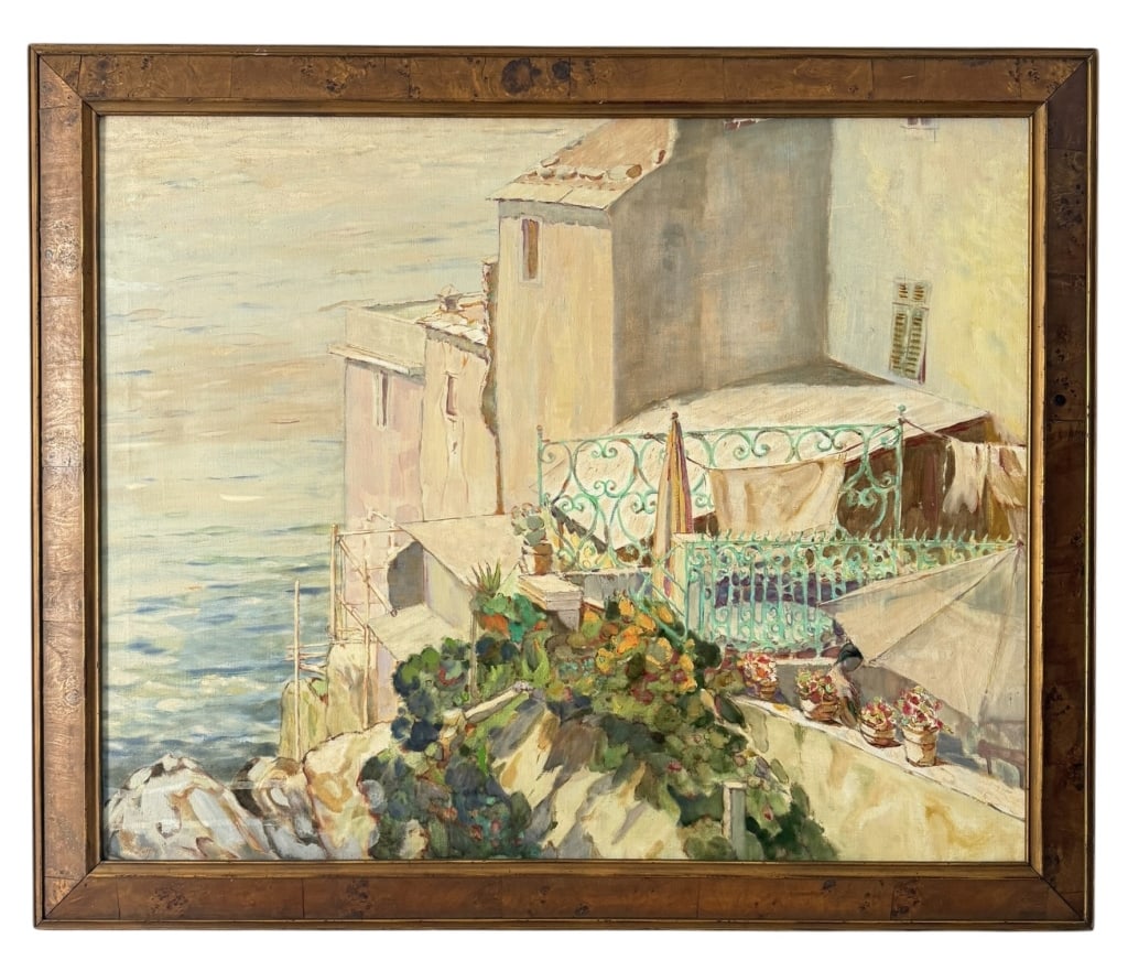 SIGNED MEDITERRANEAN COASTAL TERRACE OIL PAINTING: Mid-20th century oil on canvas depicting a sunlit Mediterranean coastal scene with stucco buildings overlooking the sea. The composition features an ornate turquoise wrought-iron terrace with hanging 