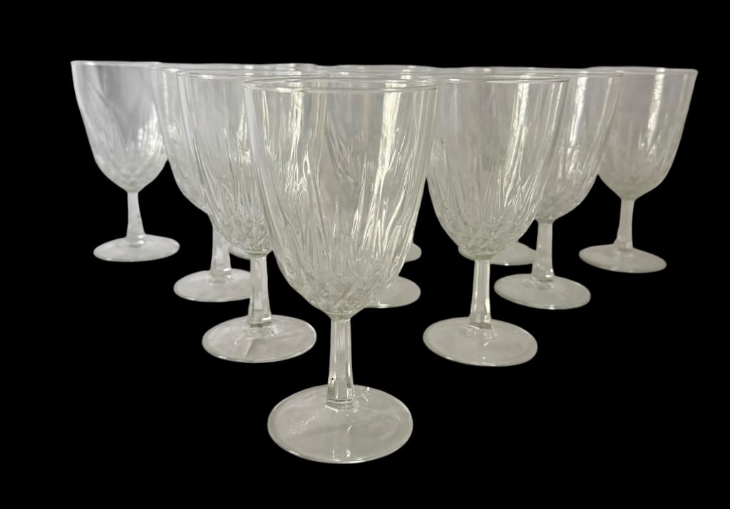 SET OF 11 FRENCH CRYSTAL WINE GOBLETS: Set of eleven vintage French clear crystal wine goblets featuring elongated leaf and flame-form cut or molded decoration rising from the lower bowls. Each with a short faceted stem and circular foot. 