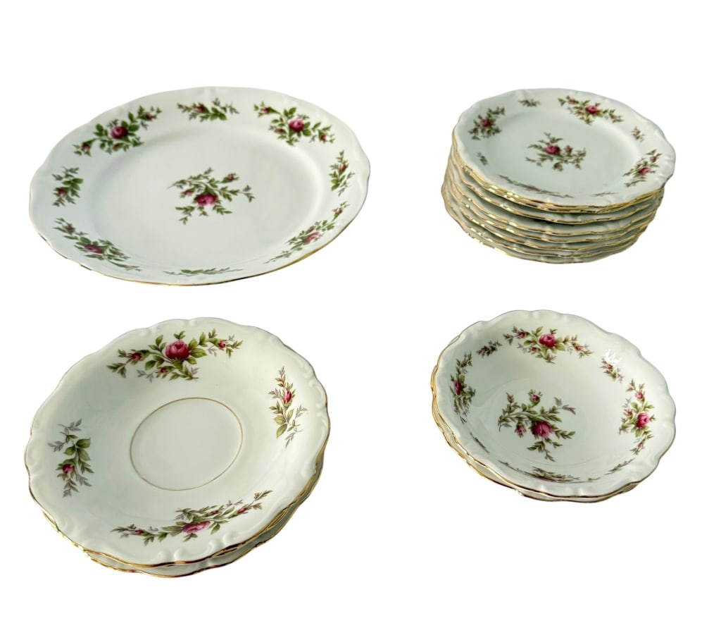 14-PIECE JOHANN HAVILAND PORCELAIN DINNERWARE SET: A 14-piece vintage Johann Haviland, Bavaria, Germany porcelain dinnerware grouping. The service features a white porcelain ground decorated with scattered sprays of pink and burgundy roses with green 