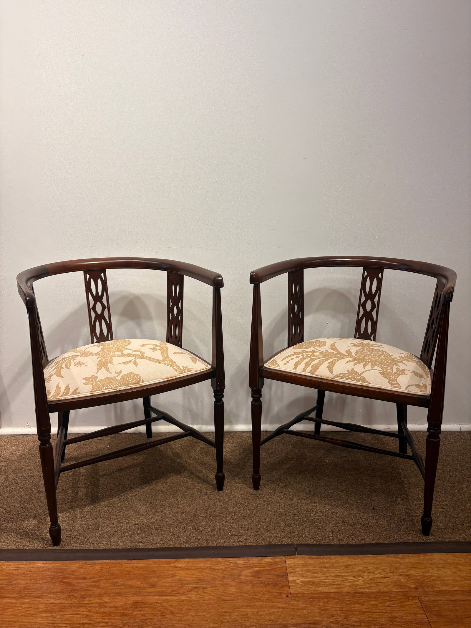 Antique Edwardian Mahogany Chairs: A pair of antique Edwardian quality mahogany inlaid tub chairs, standing on inlaid tapered legs.Measurements 21" W x 19" D X 28" HProvenance: Weston,CT