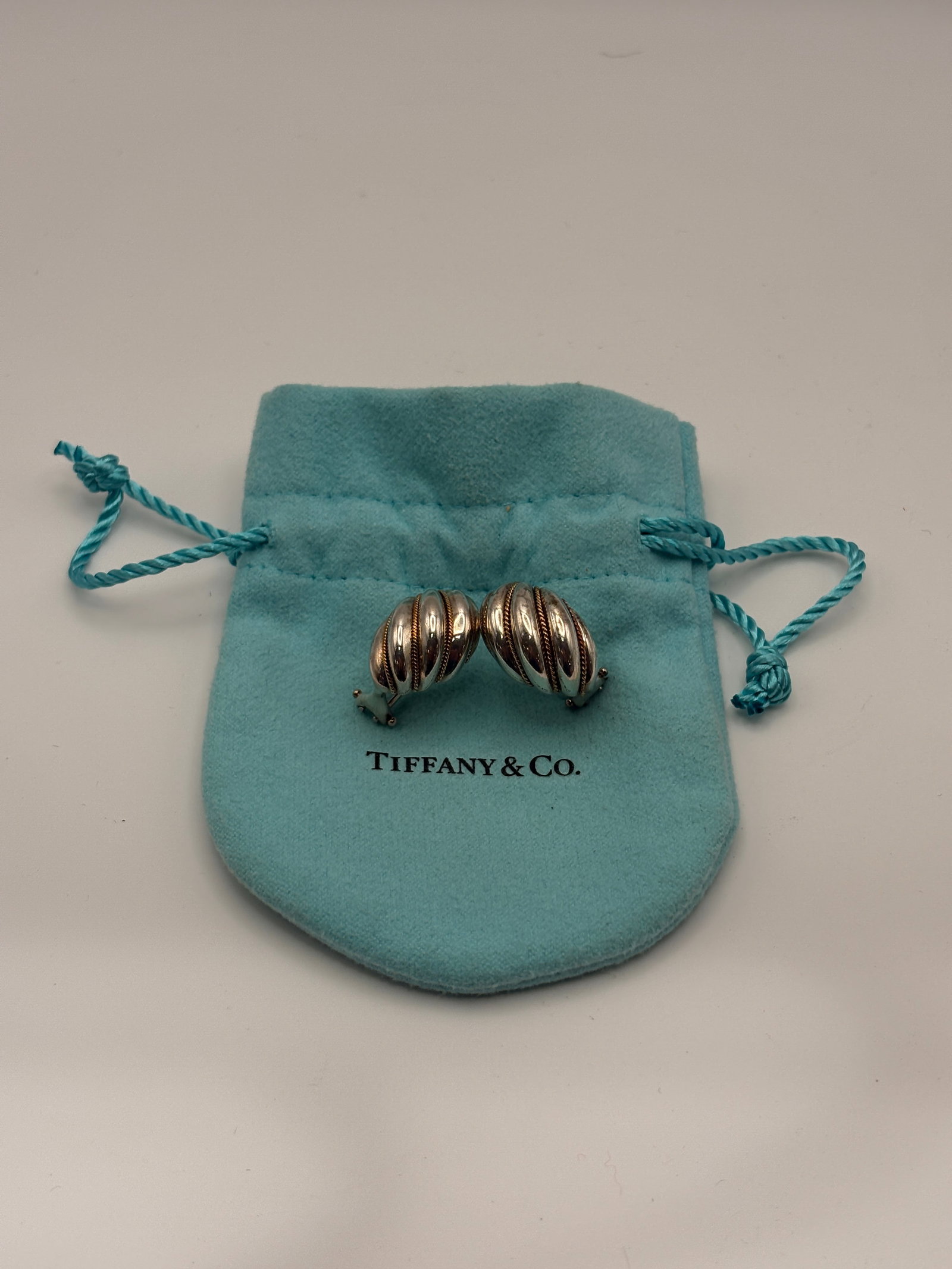 Tiffany & Co 18K & Sterling Silver Earrings: Tiffany and Company Sterling Silver Fluted Earrings Rope Design with Pouch, hardly ever used.It is stamped Tiffany and Co 925 and 750(18K)Provenance: Westport,CT