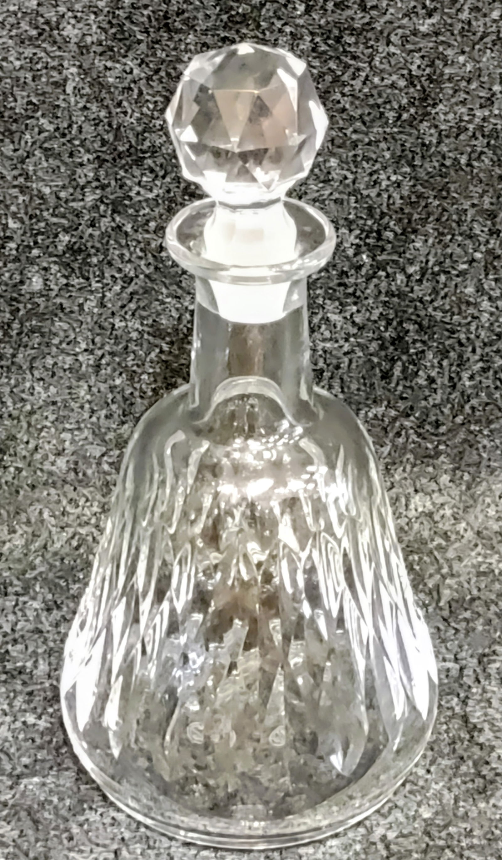 8" tall Decanter by "Baccarat": French Crystal Decanter by Baccarat, "Armagnac" pattern, a distinctive diamond pattern cut into the crystal, with a matching stopper that also has a faceted design. It is crafted from high-quality cry