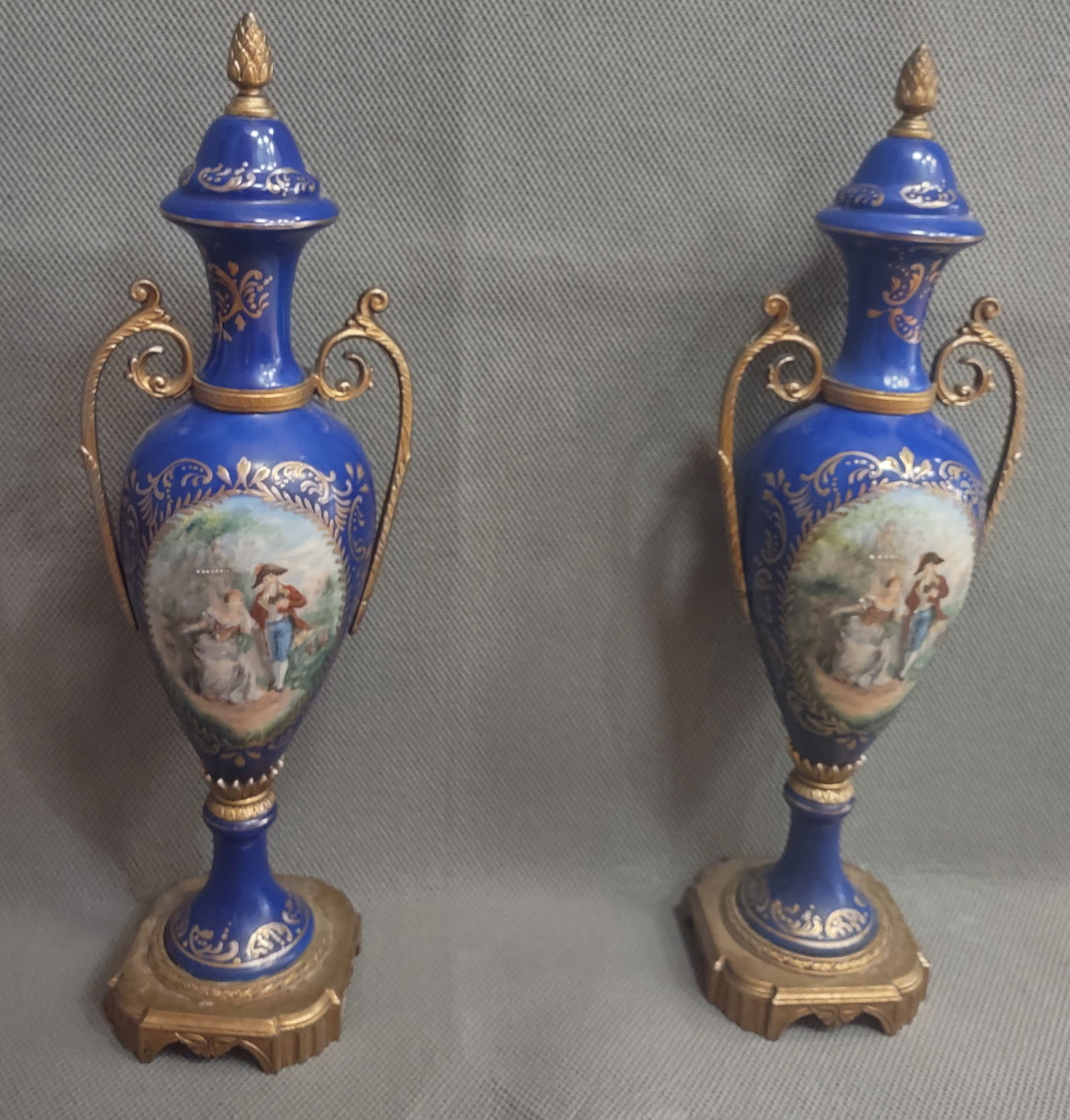 Pair of French Sevres Style Urn Vases: French Sevres Style Urn Vases Ormolu Hand Painted Porcelain Royal Blue Set of Two. 17" H x 4.5" W X 3.75" D. In great condition, No Chips or cracks.