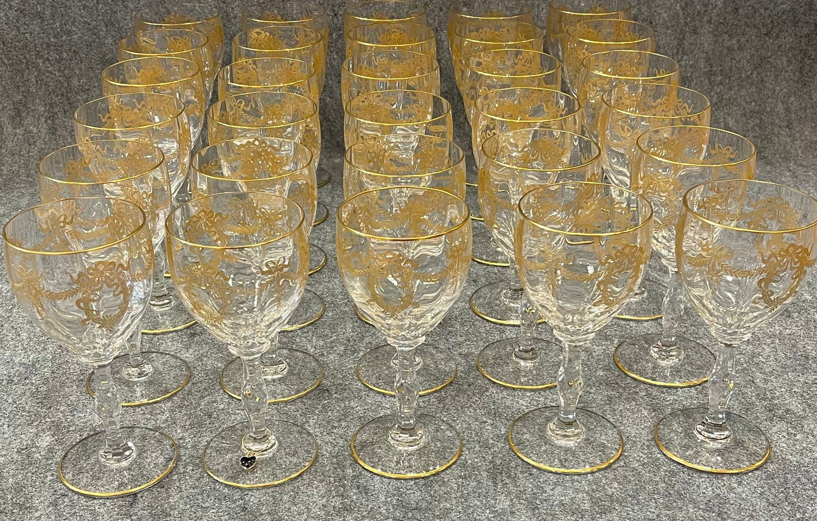 30 French GildedStemware Wine Glasses by "Saint-Louis": 30 French Gilded Saint-Louis Stemware Champagne Glasses. An elegant 19th century crystal wine glasses, each one generously embellished with a gilt rim. Each glass sits on a beautifully shaped cut and