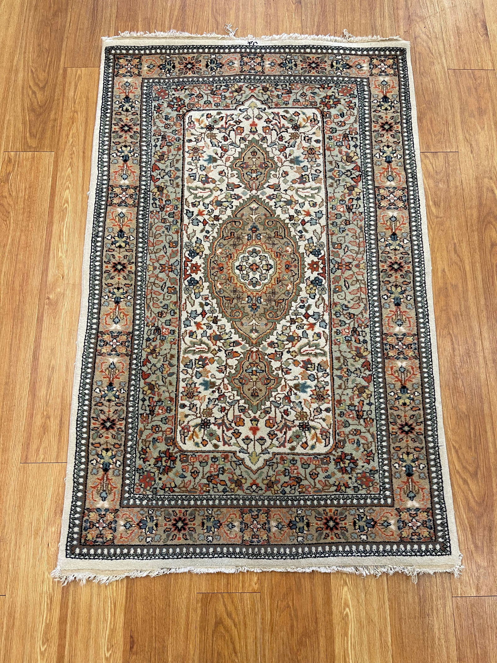 Oriental Rug 3'2" x 5'1": A finely woven Oriental rug featuring a traditional central medallion design set within an intricate field of decorative motifs. The rug has a soft wool pile and displays a balanced color palette