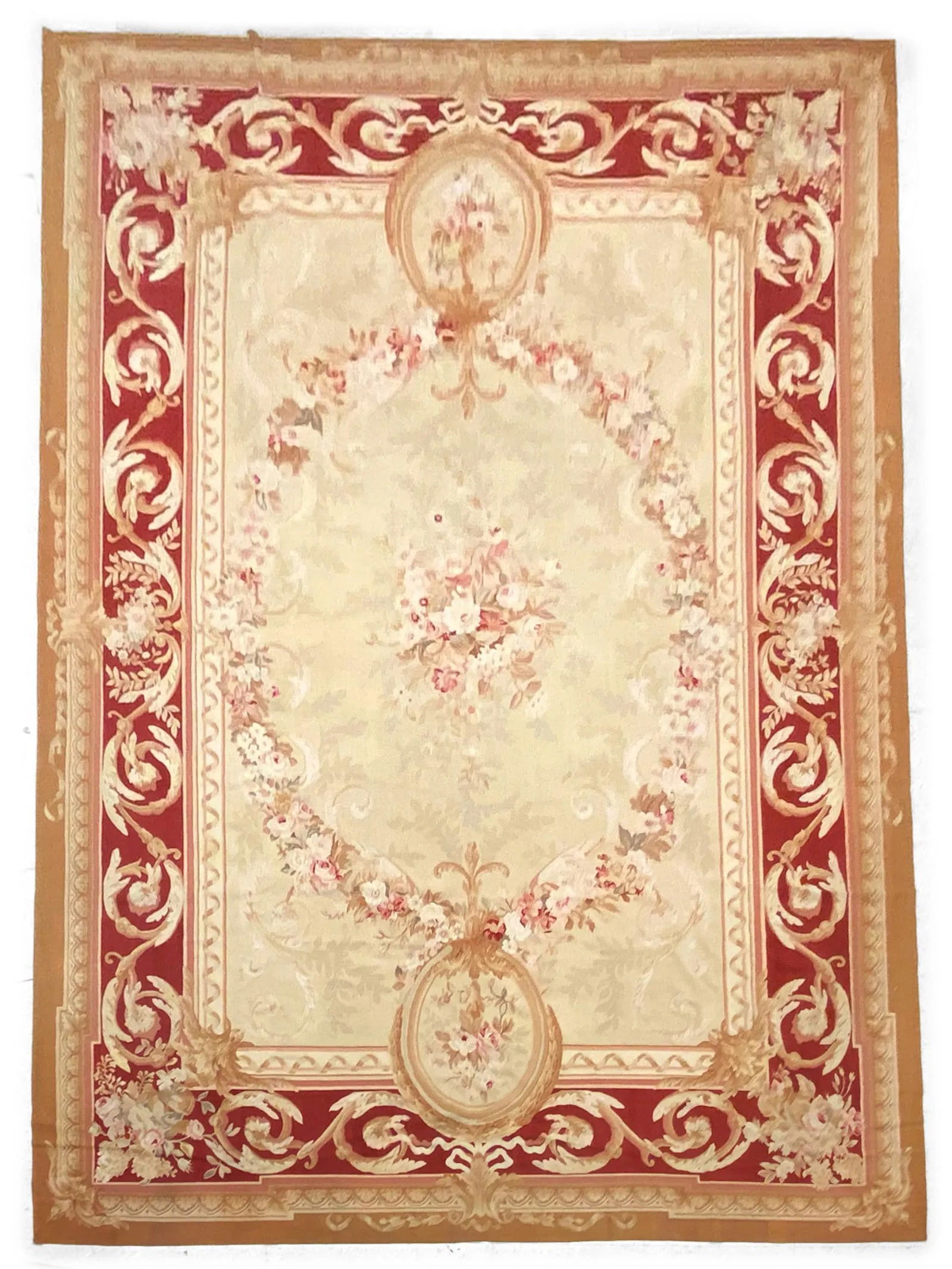Aubusson Flat Woven Carpet 11'9" x18'2": An elegant Aubusson-style carpet featuring a soft cream field centered with a delicate floral wreath and bouquet, framed by a rich red border with scrolling foliate motifs and floral accents. The