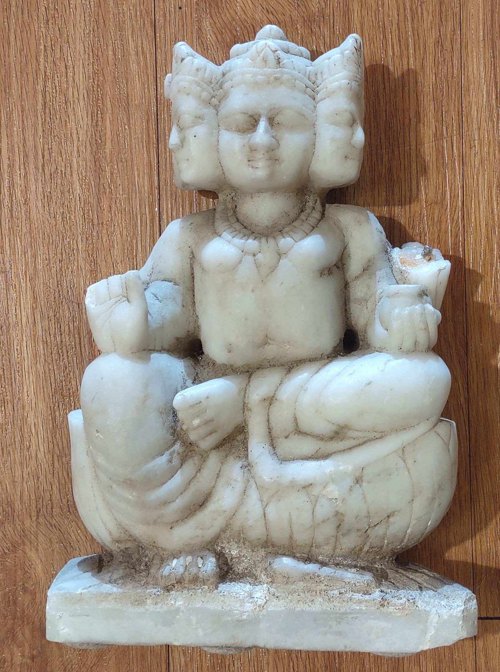 Antique Marble Worship Hindu God: A hand-carved Marble sculpture depicting the four-faced Hindu deity Brahma, shown seated in a meditative pose. The figure features traditional iconography, including multiple faces symbolizing