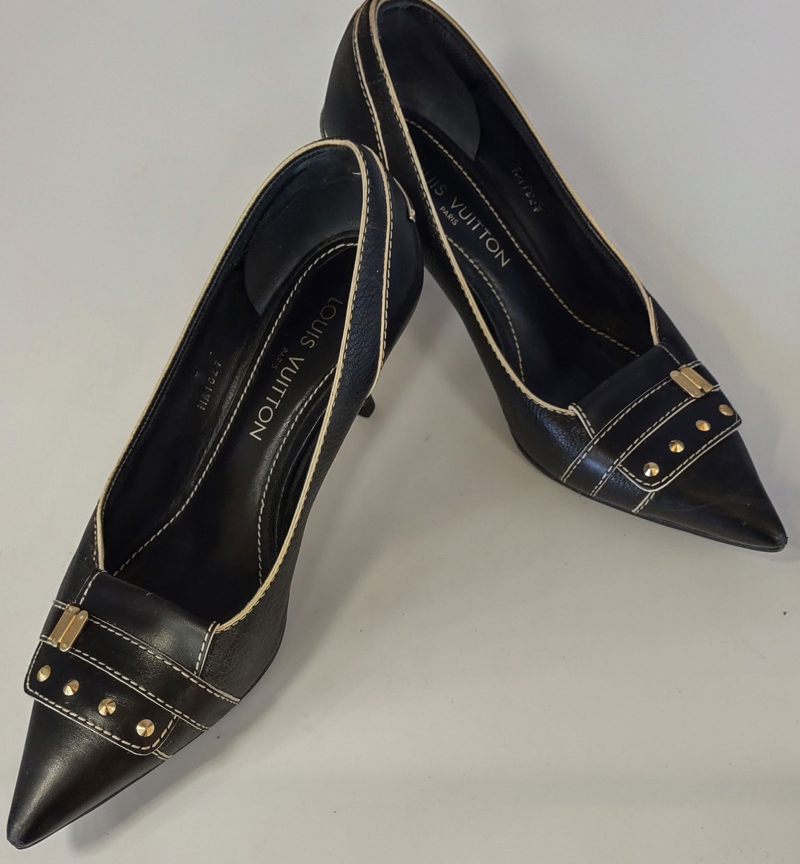 Elegant High heels Shoes by "Louis Vuitton Size 37 1/2: A pair of Louis Vuitton Black Leather Heels featuring Mastic-Colored Stitching and Decorative Brand- Inscibed gilding on the upper. Size 37 1/2