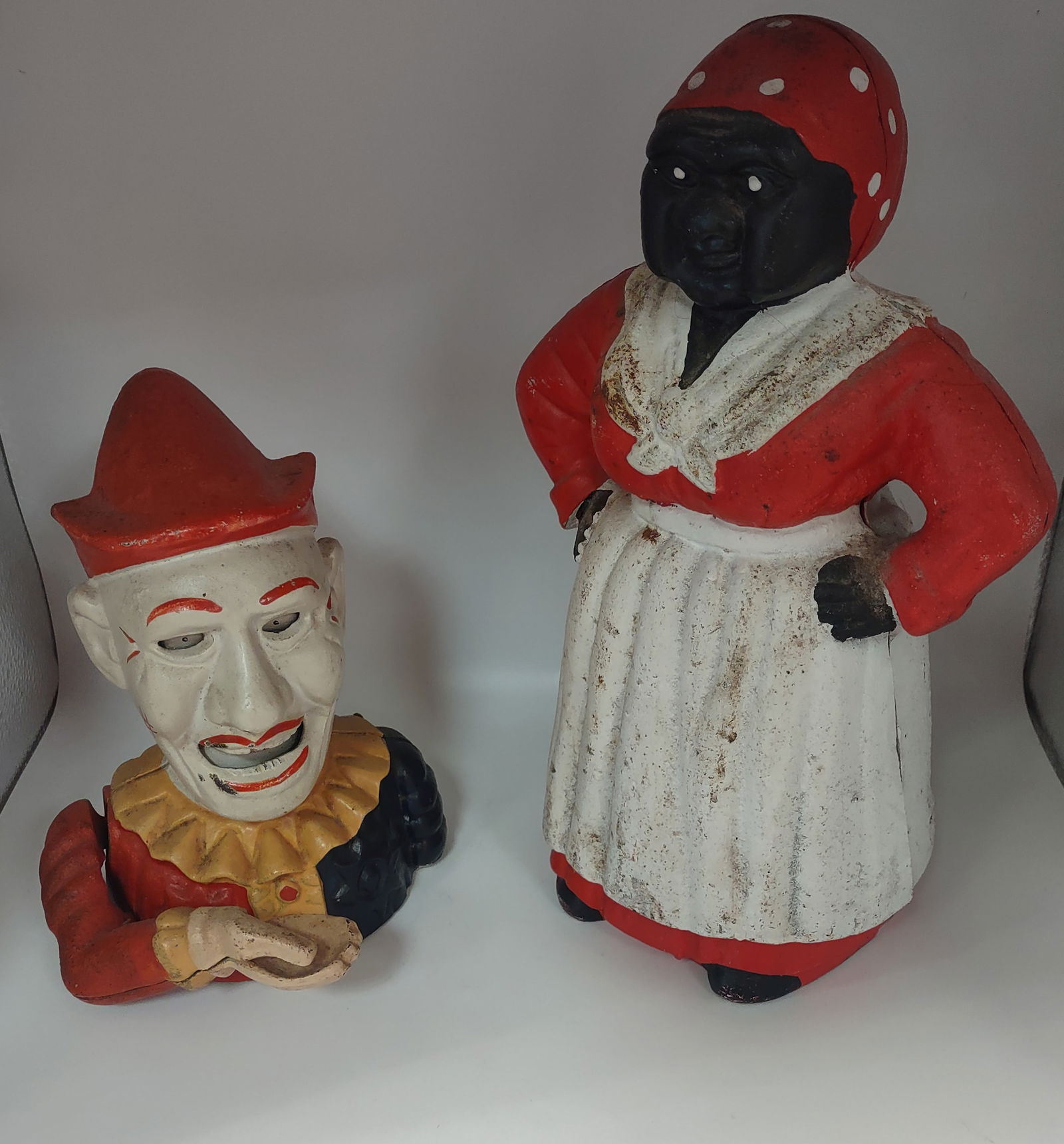 2 Cast Iron Banks: Humpty Dumpty Bank Cast Iron Mechanical Clown and Antique Cast Iron Black Americana Coin Bank.This Cast Iron Black Americana Coin Bank is a unique piece of Black Americana History that is sure to be a