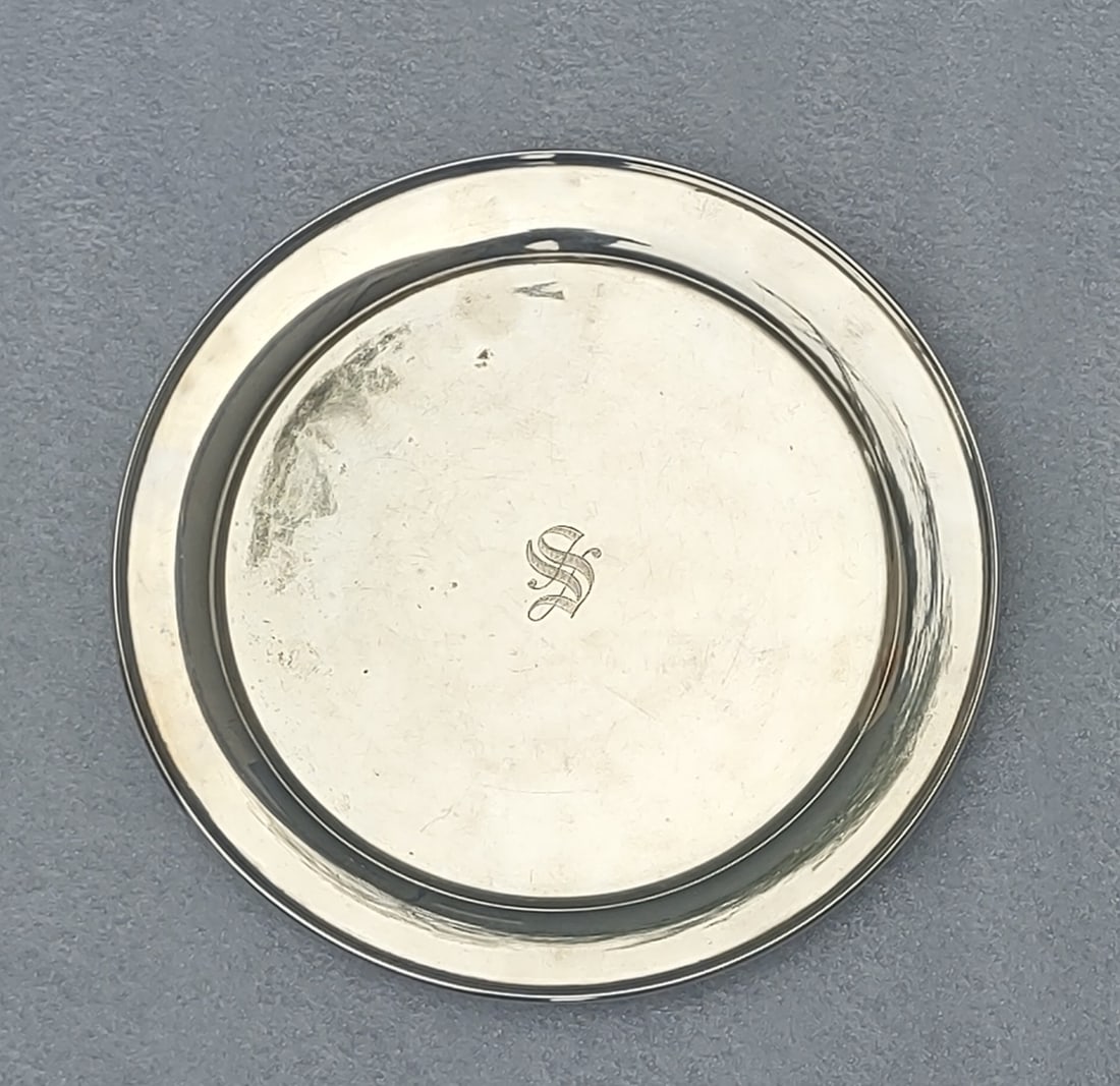 10" Sterling Silver Serving Plate: Sterling Silver serving plate measuring approximately 10 inches in diameter, stamped “J.S.Co. Sterling C 3139.” Monogrammed center with classic form and elegant simplicity. Total weight