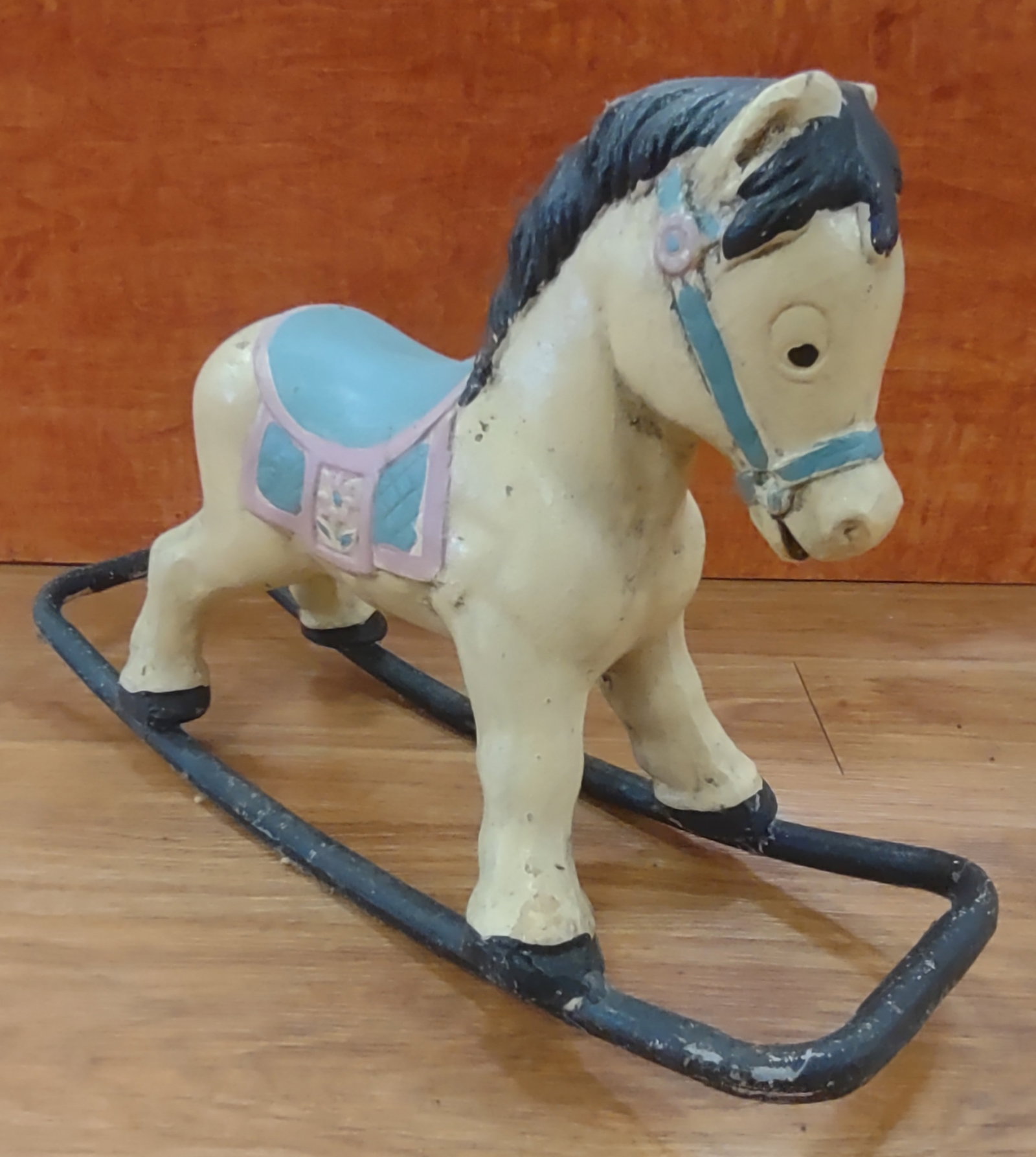 Antique Rocking Horse: Antique cast iron rocking horse retaining its original painted colors and charming early character. Finely cast with classic form and decorative detail, displaying expected wear consistent with age