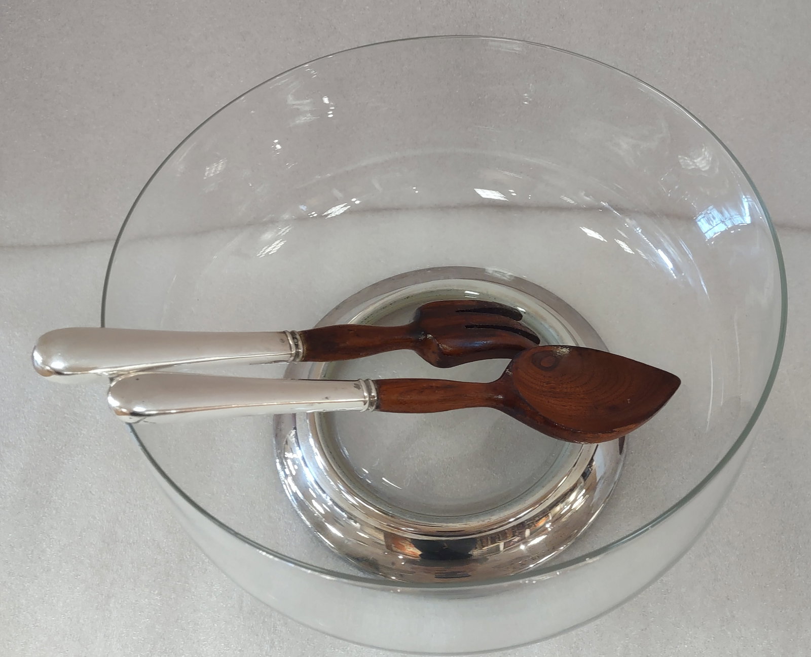A Glass Salad Bowl Set with Sterling Silver: Elegant glass salad bowl set featuring a serving utensils sterling silver-mounted handles. The bowl measures approximately 10.5 inches in diameter, accompanied by a 10-inch long serving set.