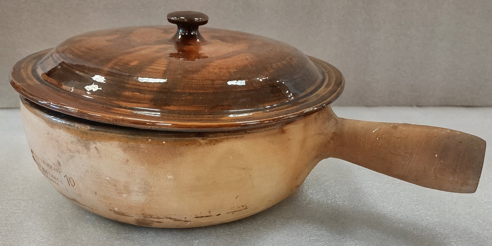 Antique "Vallauris" Terra Cotta French Pottery Covered Casserloe with Handle: Very old terra cotta covered casserole marked “Vallauris, Made in France,” featuring a traditional handled form and rustic earthenware construction. The interior of the base is glazed with a