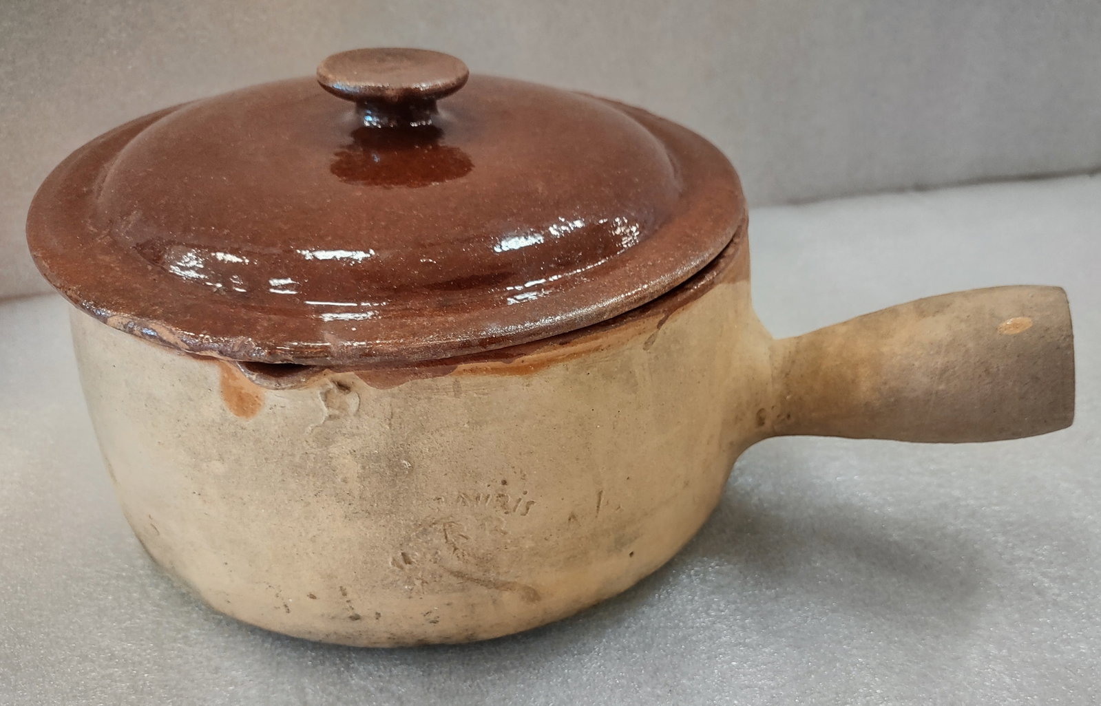 Antique "Vallauris" Terra Cotta French Pottery Covered Casserloe with Handle: Very old terra cotta covered casserole marked “Vallauris, Made in France,” featuring a traditional handled form and rustic ceramic construction. Interior of the base is glazed with a brownish