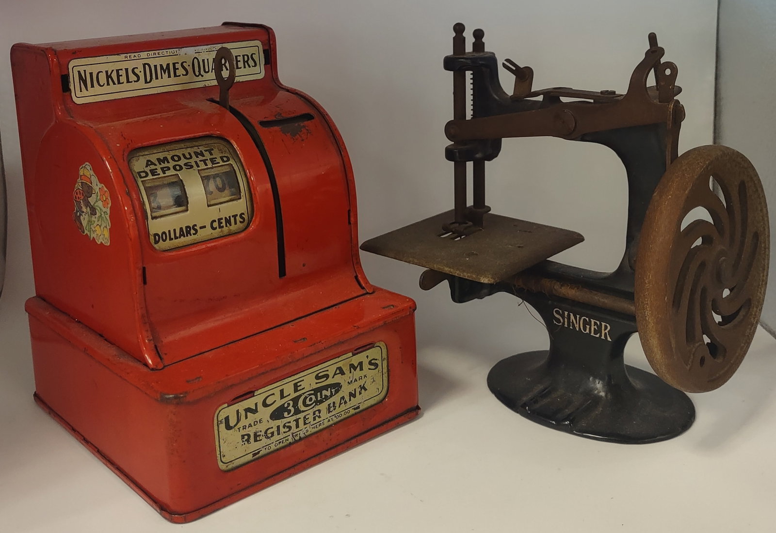 Vintage Uncle Sam 3 Coin Bank Toy and 1910 Singer Model 20 Sewing Machine: Vintage Uncle Sam 3 Coin Bank Toy with coins inside and a 1910 Singer Model 20 Sewing Machine, Not tested. Shipping: Multiple shipping options available. In-house shipping or local pickup is