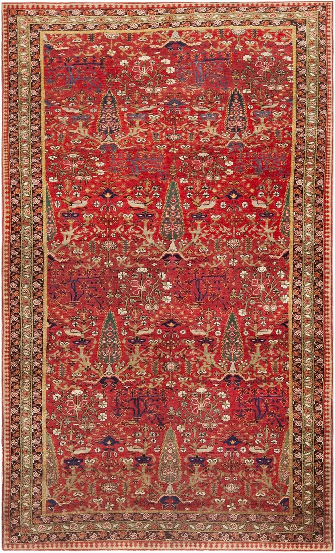 Antique Persian Kerman Cypress Tree Design Rug 6 ft 8 in x 4 ft (2.03 m x 1.22 m): Curated collection of antique, vintage and modern rugs Size: 6 ft 8 in x 4 ft (2.03 m x 1.22 m) Provenance: Purchased from Bonhams auction Cypress trees rise through the red field of this antique Pers
