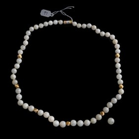 A Chinese carved white jadeite beaded necklace