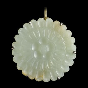 A Chinese carved jade 'chrysanthemum' buckle, Ming dynasty